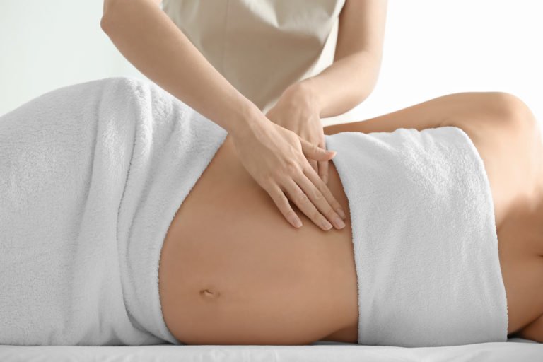 Young,Beautiful,Pregnant,Woman,Having,Massage,In,Spa,Salon